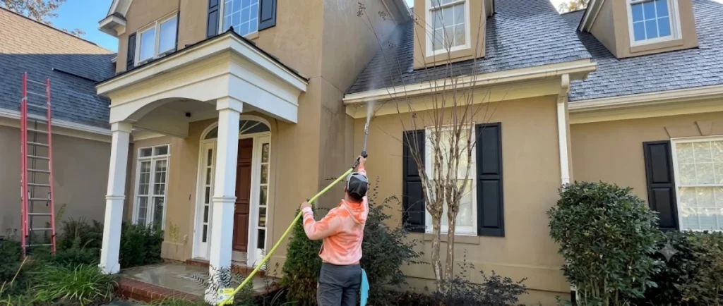House Washing Naples FL removing algae, mildew, and dirt from a residential stucco home's exterior.